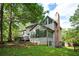 Spacious backyard featuring a deck, enclosed sunroom, and lush green lawn at 13789 Woolsey Rd, Hampton, GA 30228