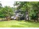 Beautiful backyard with a wooden deck, a privacy fence and mature trees at 13789 Woolsey Rd, Hampton, GA 30228