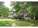 A backyard view featuring a deck, a screened-in porch, and lush greenery at 13789 Woolsey Rd, Hampton, GA 30228