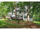 Lush backyard with a deck with railings, mature trees providing shade at 13789 Woolsey Rd, Hampton, GA 30228
