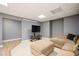 Finished basement with gray walls, neutral carpet, and a comfortable seating area at 13789 Woolsey Rd, Hampton, GA 30228