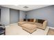 Basement living room featuring a sectional couch with pillows, an ottoman, and neutral carpet at 13789 Woolsey Rd, Hampton, GA 30228