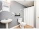 Bathroom with light gray walls, a sink, a toilet, and a shower with a white shower curtain at 13789 Woolsey Rd, Hampton, GA 30228