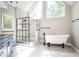 Bright bathroom with a walk-in glass shower, soaking tub, and elegant black matte fixtures at 13789 Woolsey Rd, Hampton, GA 30228