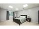 Spacious bedroom with a bed, matching side tables, and wall to wall carpet at 13789 Woolsey Rd, Hampton, GA 30228