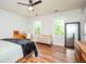 Bedroom with hardwood flooring and two windows at 13789 Woolsey Rd, Hampton, GA 30228
