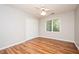 Bedroom with laminate flooring, a window, a ceiling fan, and a built-in closet at 13789 Woolsey Rd, Hampton, GA 30228