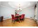 Dining room boasts hardwood floors, a modern chandelier, and ample natural light at 13789 Woolsey Rd, Hampton, GA 30228
