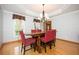 Bright dining room features hardwood floors, tray ceiling, and modern chandelier lighting at 13789 Woolsey Rd, Hampton, GA 30228
