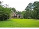 Spacious home with a well-maintained lawn and mature trees at 13789 Woolsey Rd, Hampton, GA 30228