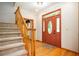 Cozy foyer with hardwood floors, staircase, and a welcoming front door at 13789 Woolsey Rd, Hampton, GA 30228