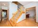 Bright foyer featuring hardwood floors, staircase, and access to dining room at 13789 Woolsey Rd, Hampton, GA 30228