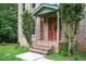 Inviting front porch with brick steps and a colorful front door at 13789 Woolsey Rd, Hampton, GA 30228