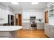 Bright kitchen with hardwood floors, stainless steel appliances, and center island with breakfast bar at 13789 Woolsey Rd, Hampton, GA 30228