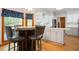 Eat-in kitchen with custom cabinets, hardwood floors, modern fixtures, and plenty of natural light at 13789 Woolsey Rd, Hampton, GA 30228