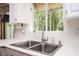 Kitchen sink and countertop features a modern faucet, white tiled backsplash, and window with natural light at 13789 Woolsey Rd, Hampton, GA 30228