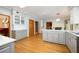 Spacious kitchen with hardwood floors, gray cabinets, stainless appliances, and easy access to other rooms at 13789 Woolsey Rd, Hampton, GA 30228