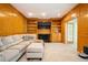 Comfortable living room with wood paneling, built-in shelves, and a fireplace at 13789 Woolsey Rd, Hampton, GA 30228