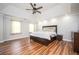 Bright main bedroom with trey ceiling, modern ceiling fan, and hardwood floors at 13789 Woolsey Rd, Hampton, GA 30228