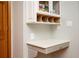 An office nook area features a countertop desk, drawer space, overhead cabinets, and decor shelving at 13789 Woolsey Rd, Hampton, GA 30228
