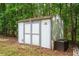 Exterior view of ' Shed' on the property with double doors and storage box at 13789 Woolsey Rd, Hampton, GA 30228