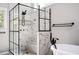 Luxurious walk-in shower with marble tile and black matte fixtures at 13789 Woolsey Rd, Hampton, GA 30228