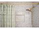 Shower with green curtain and gold shower head at 13789 Woolsey Rd, Hampton, GA 30228