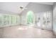 Light-filled sun room featuring tile floors, vaulted ceilings, and walls of windows at 13789 Woolsey Rd, Hampton, GA 30228
