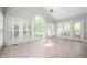 Bright sun room with tile flooring and lots of windows offering views of the lush greenery at 13789 Woolsey Rd, Hampton, GA 30228