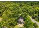 An aerial view of a home nestled among green trees with a driveway and road nearby at 2468 Fallview Ter, Atlanta, GA 30344