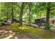 Expansive backyard featuring a shed, lush lawn, and a view of the house with a screened-in porch at 2468 Fallview Ter, Atlanta, GA 30344