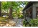 Landscaped backyard featuring a stone pathway, lush plantings, and a charming porch at 2468 Fallview Ter, Atlanta, GA 30344