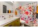 Charming bathroom with modern vanity, floral shower curtain and planked walls at 2468 Fallview Ter, Atlanta, GA 30344
