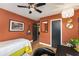 Stylish bedroom boasts hardwood floors, ceiling fan, and fun wall decor at 2468 Fallview Ter, Atlanta, GA 30344