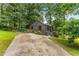 Charming gray home featuring wooden shutters, meticulous landscaping, and a unique driveway at 2468 Fallview Ter, Atlanta, GA 30344