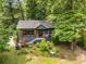 Aerial view of cozy home with wooded landscaping, a dark exterior, and a well-maintained front yard at 2468 Fallview Ter, Atlanta, GA 30344