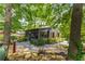Charming home exterior with a screened porch, lush landscaping, and a peaceful backyard setting at 2468 Fallview Ter, Atlanta, GA 30344