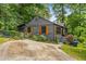 Charming gray home featuring wooden shutters, meticulous landscaping, and a unique driveway at 2468 Fallview Ter, Atlanta, GA 30344