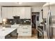 Beautiful kitchen with white cabinets, mosaic backsplash, stainless steel appliances, and marble island at 2468 Fallview Ter, Atlanta, GA 30344
