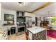 Well lit kitchen with stainless steel appliances, marble island, and dining area in the background at 2468 Fallview Ter, Atlanta, GA 30344