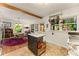 Bright kitchen with island, stainless appliances, and hardwood floors that open to dining area at 2468 Fallview Ter, Atlanta, GA 30344