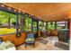 Relaxing sun room with wood paneled walls and ceiling, tile floors, and view of the backyard at 2468 Fallview Ter, Atlanta, GA 30344