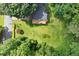 Lush aerial view of home featuring a deck and large grassy yard with mature trees at 2600 Sandpiper Dr, Tucker, GA 30084