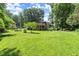 Wide open backyard with lush green grass and trees, featuring a spacious elevated deck at 2600 Sandpiper Dr, Tucker, GA 30084