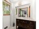 Bathroom featuring a vanity with storage, mirror, window, and neutral decor at 2600 Sandpiper Dr, Tucker, GA 30084