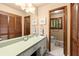 Well-lit bathroom featuring a vanity, framed mirror, and a separate toilet area at 2600 Sandpiper Dr, Tucker, GA 30084