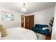 Bedroom featuring a bed, hardwood flooring, turquoise couch, and an en-suite bathroom at 2600 Sandpiper Dr, Tucker, GA 30084