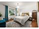 Bedroom featuring a bed, area rug, a window overlooking trees, and ample storage at 2600 Sandpiper Dr, Tucker, GA 30084
