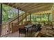 Covered deck with wooden floors, railings and stairs leading to the yard providing a shady outdoor retreat at 2600 Sandpiper Dr, Tucker, GA 30084