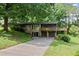 Charming home featuring a stone facade, two-car garage, and a spacious deck surrounded by lush greenery at 2600 Sandpiper Dr, Tucker, GA 30084